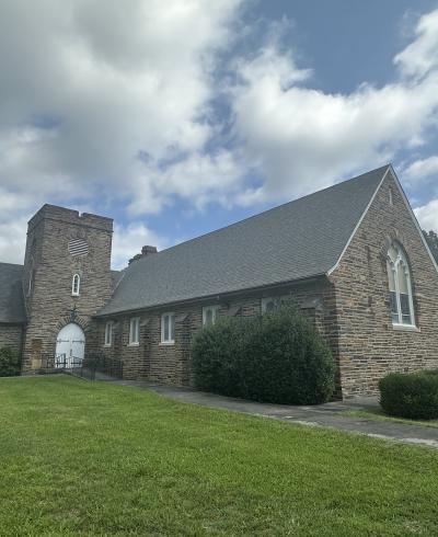 An image of the chapel's Duke stone facade, including the bell tower and sanctuary that face the street.
